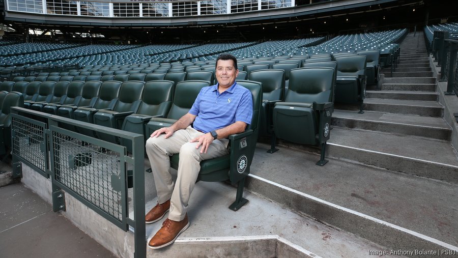 fred rivera sitting on the bleachers at the Mariners field